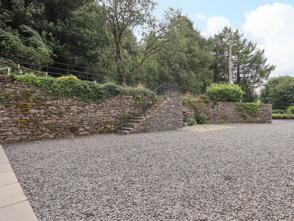 An outdoor area with a stone wall and staircase at Abbots Reading Suite, Lakeside