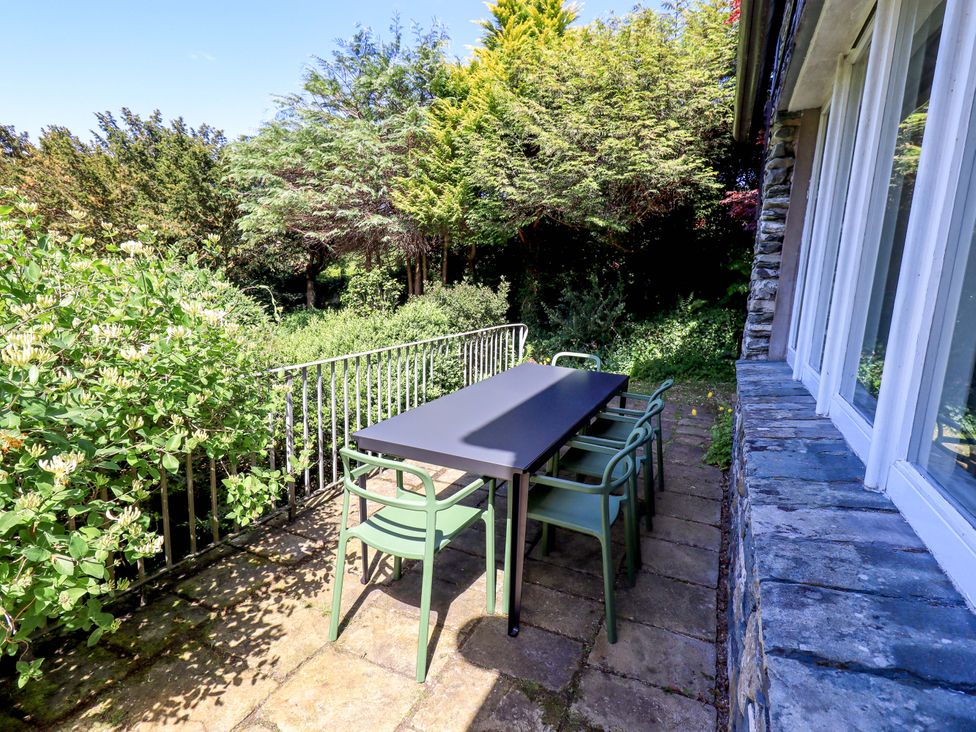 An outdoor area with a table and chairs at Tower Cottage in Windermere
