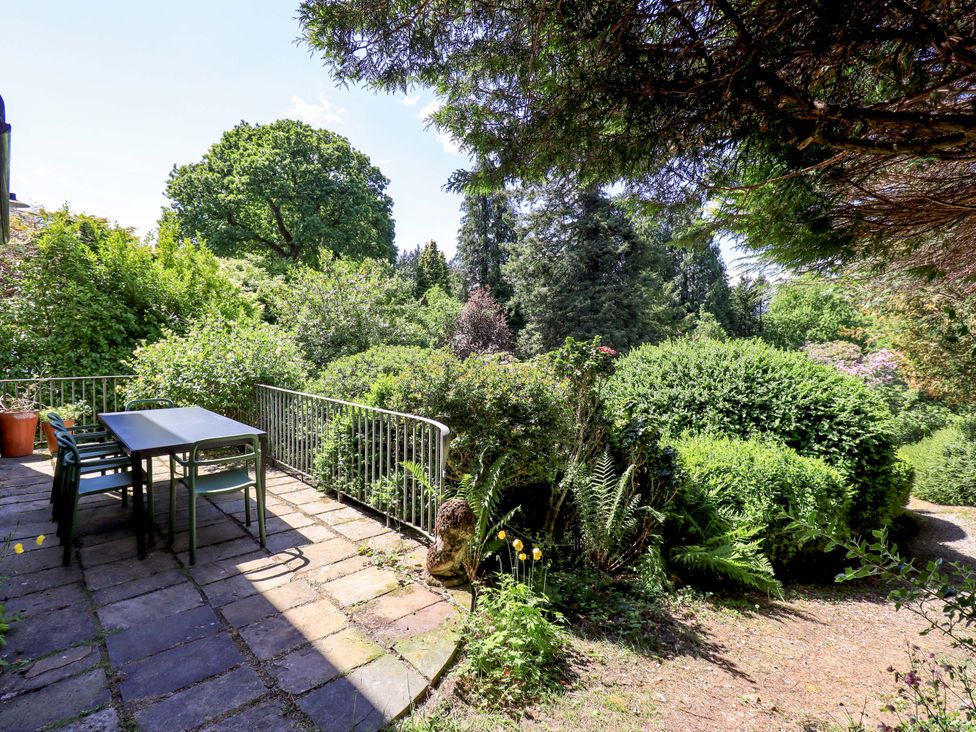 A garden with a table and chairs at Tower Cottage in Windermere