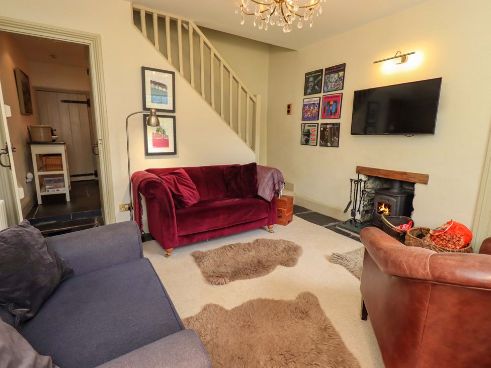 A living room with a television and a fireplace at Beck Steps in Chapel Stile