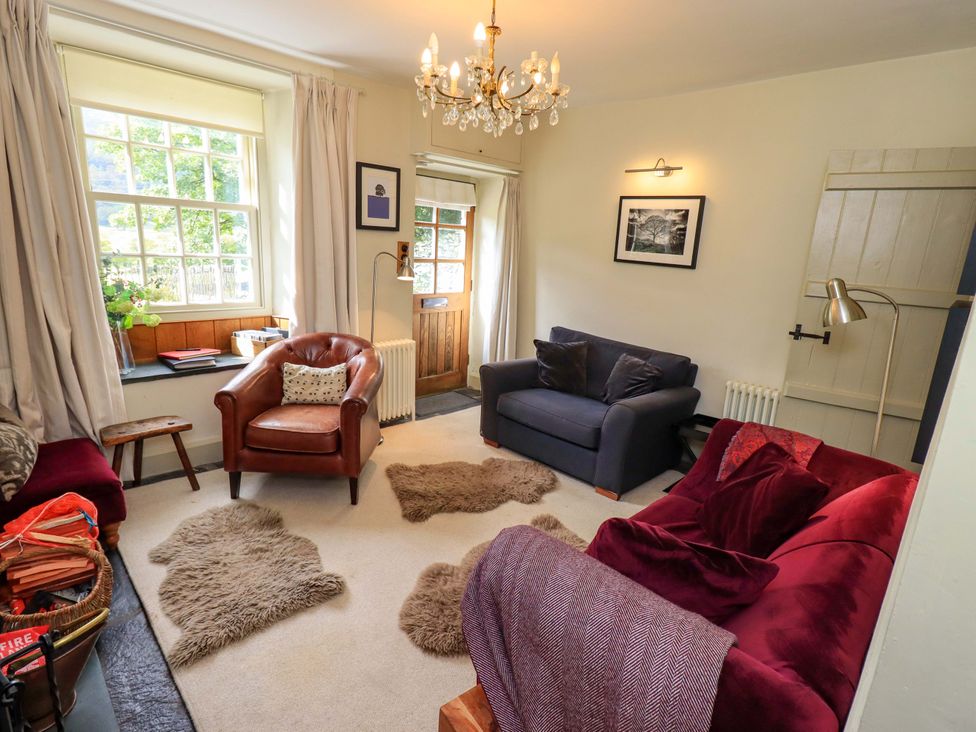 A living room with an armchair and a sofa at Beck Steps Chapel Stile