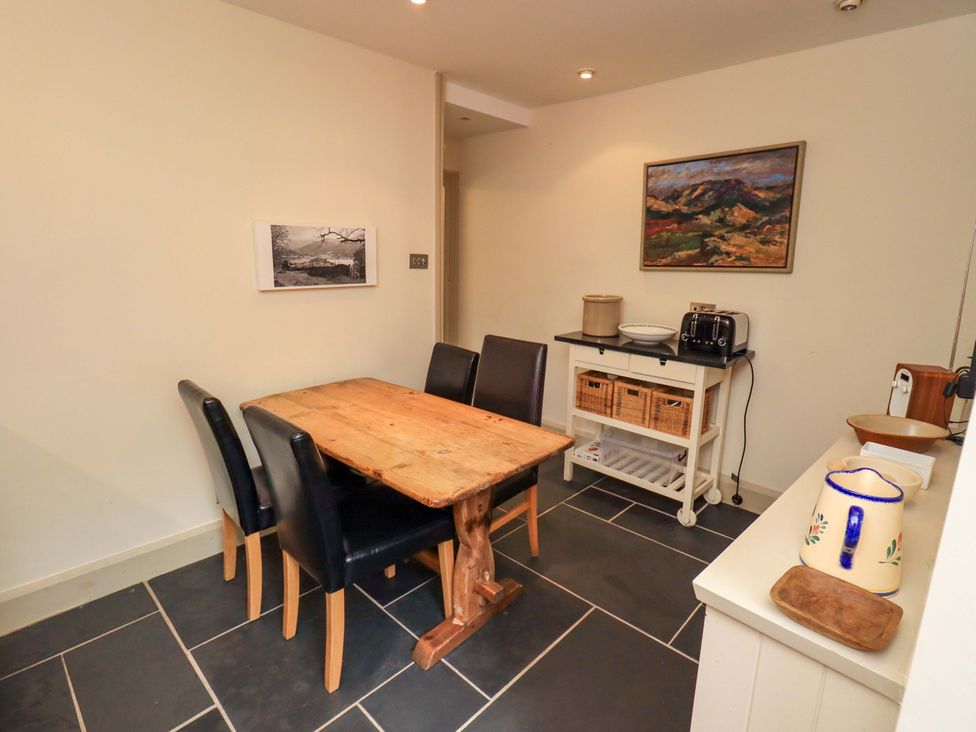 A kitchen with a wooden table and four black chairs at Beck Steps in Chapel Stile