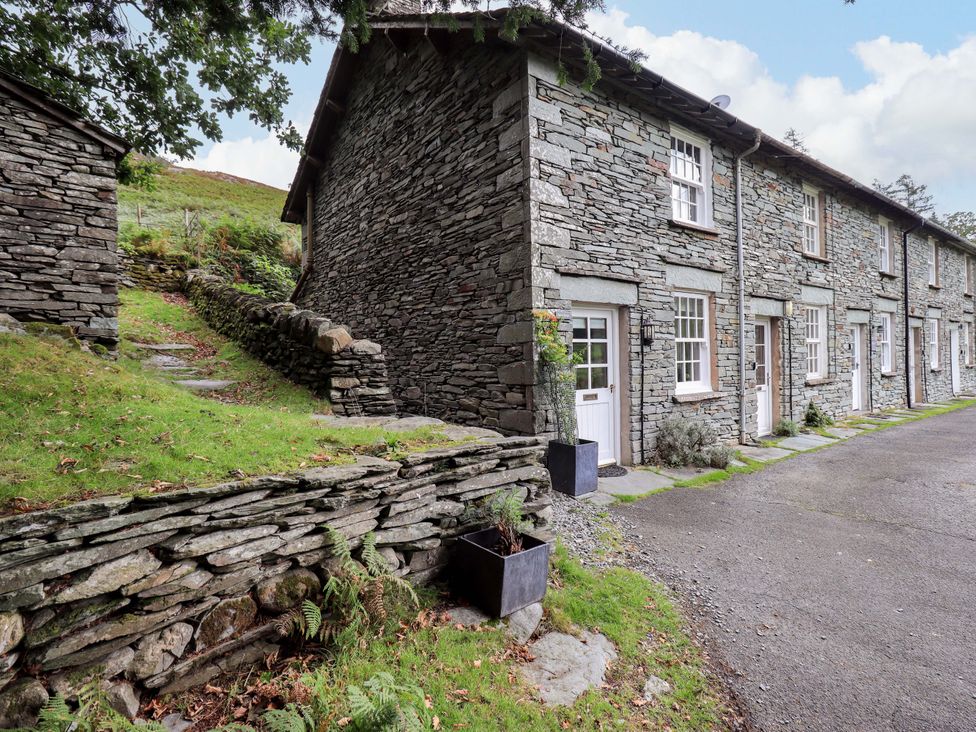 An outdoor view of a stone building with a path and planter at Beck Steps in Chapel Stile