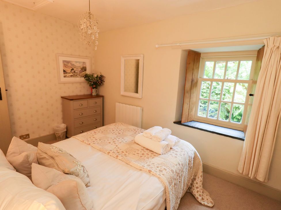 A bedroom with a double bed and window at Beck Steps in Chapel Stile
