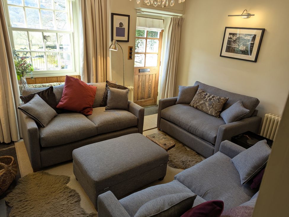 A living room with sofas and an ottoman at Beck Steps in Chapel Stile