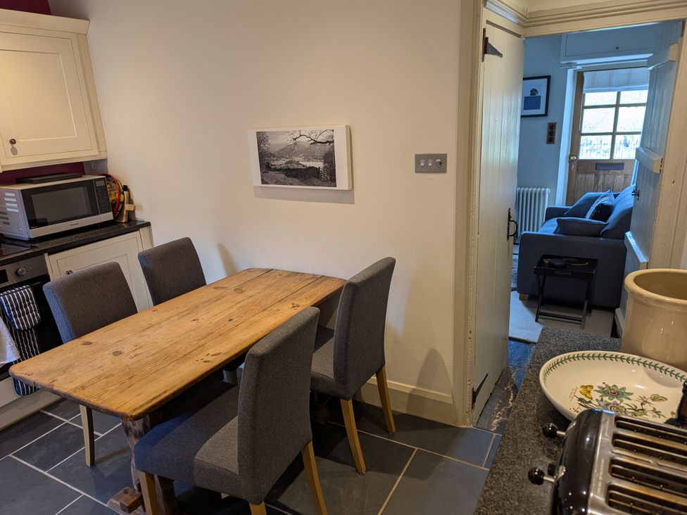 A kitchen with a wooden table and chairs at Beck Steps in Chapel Stile