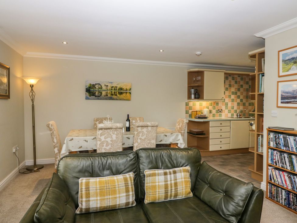 A living room with a dining area and kitchen at Middlerigg in Troutbeck
