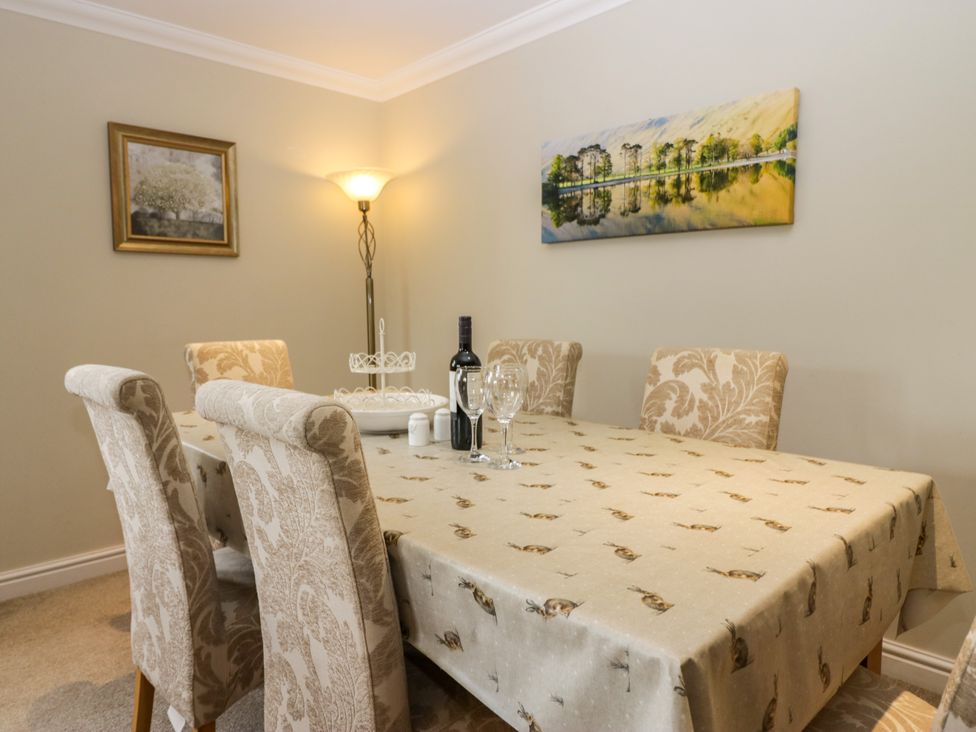 A dining room with a table and chairs at Middlerigg in Troutbeck