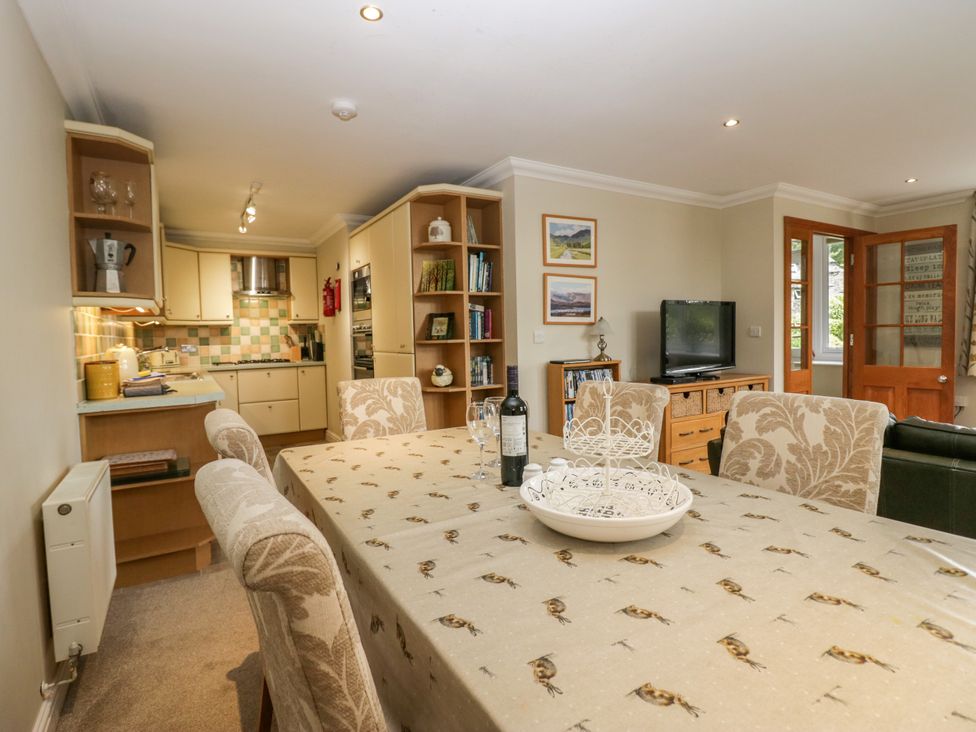 A dining room with a table and chairs at Middlerigg in Troutbeck