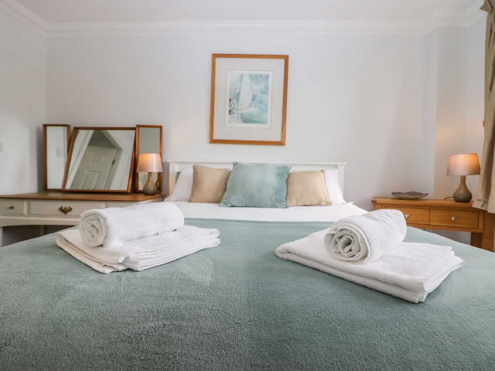 A bedroom with a bed and towels on the covers at Middlerigg in Troutbeck