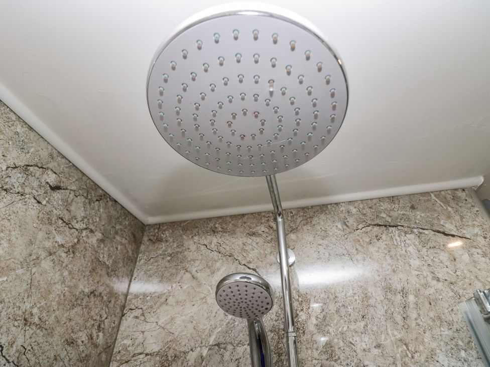 A shower head and hose in a bathroom at Middlerigg in Troutbeck
