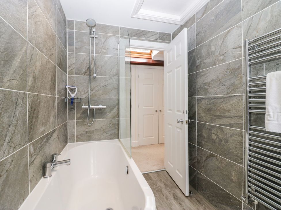 A bathroom with a bathtub and shower at Middlerigg in Troutbeck