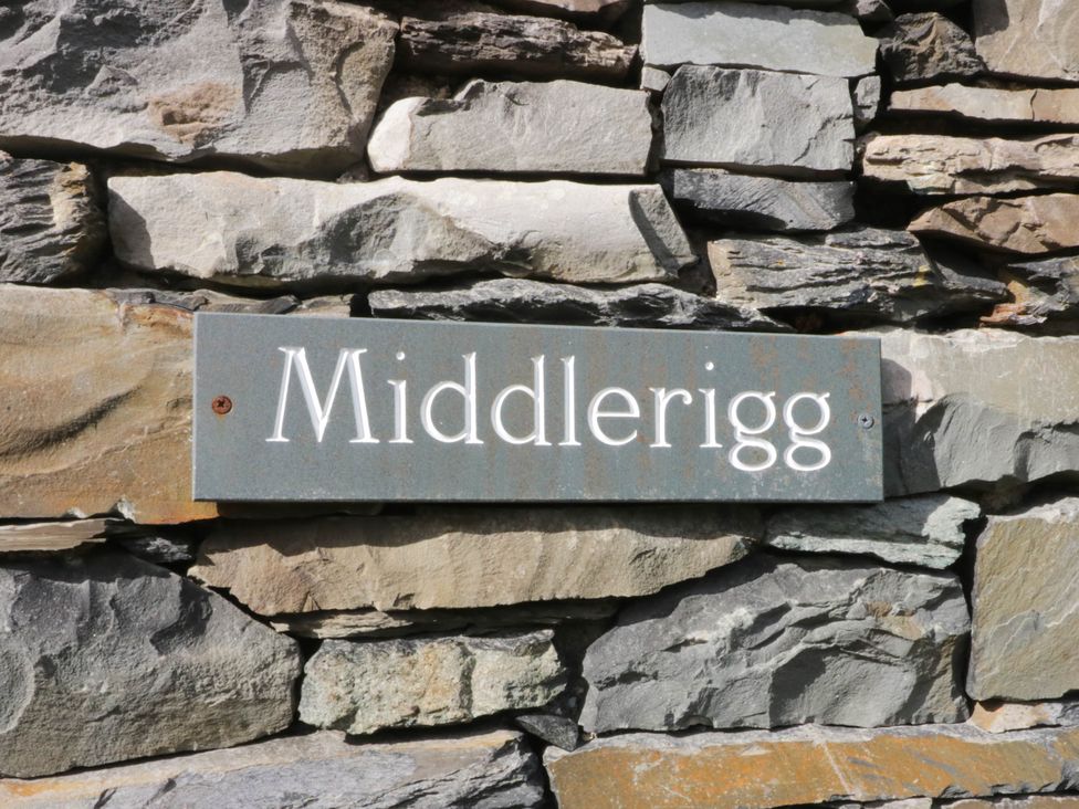 A sign reading 'Middlerigg' on a stone wall at Middlerigg in Troutbeck