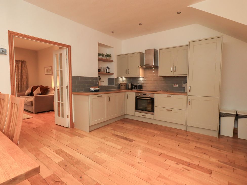 A kitchen with cabinetry and appliances at Fairfield Cottage in Grasmere