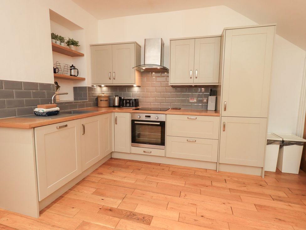 A kitchen with cabinets and an oven at Fairfield Cottage in Grasmere