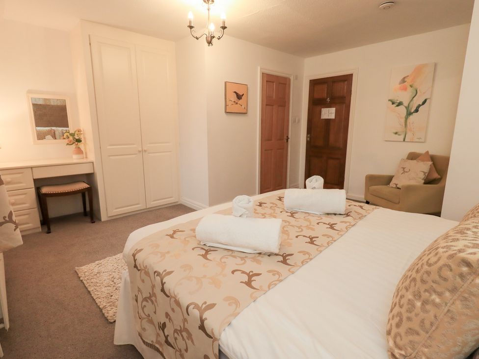 A bedroom with a bed, desk, and chair at Fairfield Cottage Grasmere