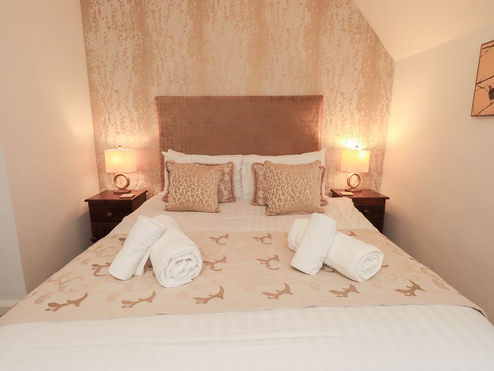 A bedroom with a bed and bedside table at Fairfield Cottage in Grasmere