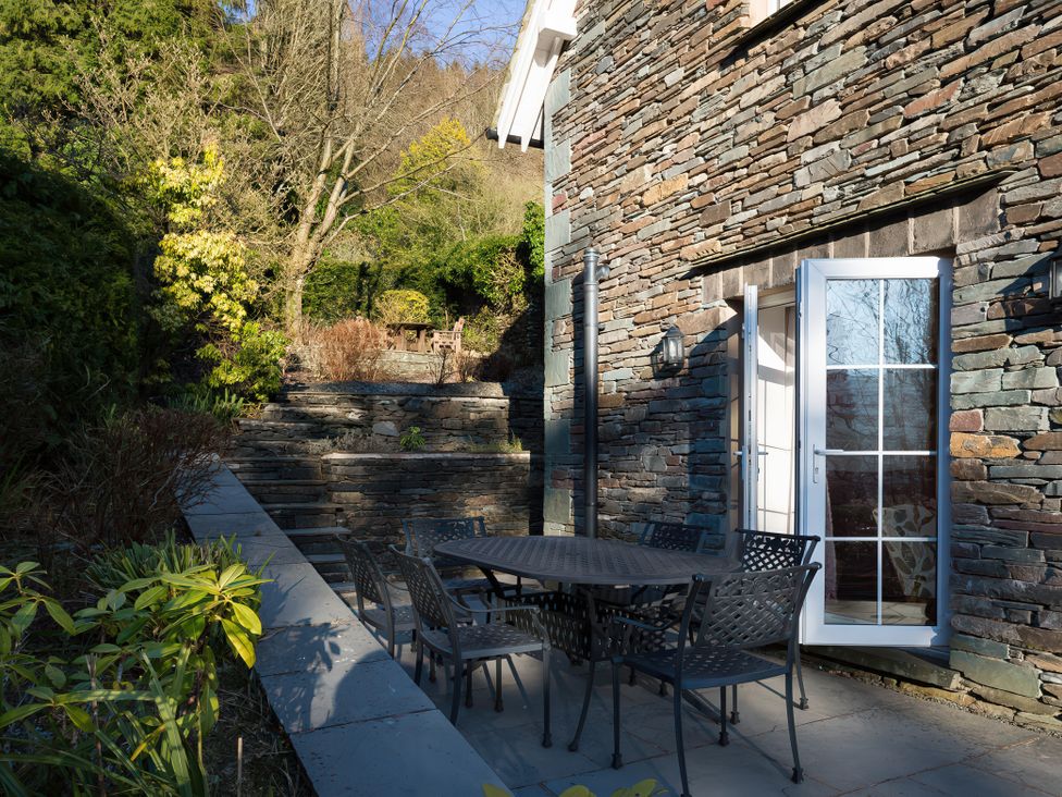 An outdoor patio with a table and chairs at Fairfield Cottage in Grasmere