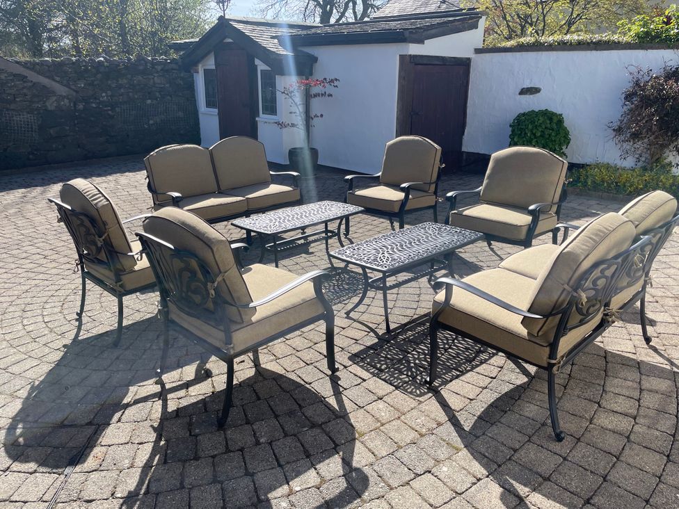 A seating area with chairs and tables at Bank Barn at Rusland in Grizedale