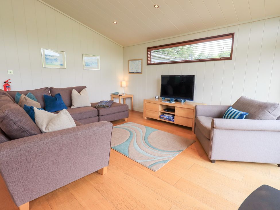 A living room with a sofa and television at Thie Loghey in Hawkshead