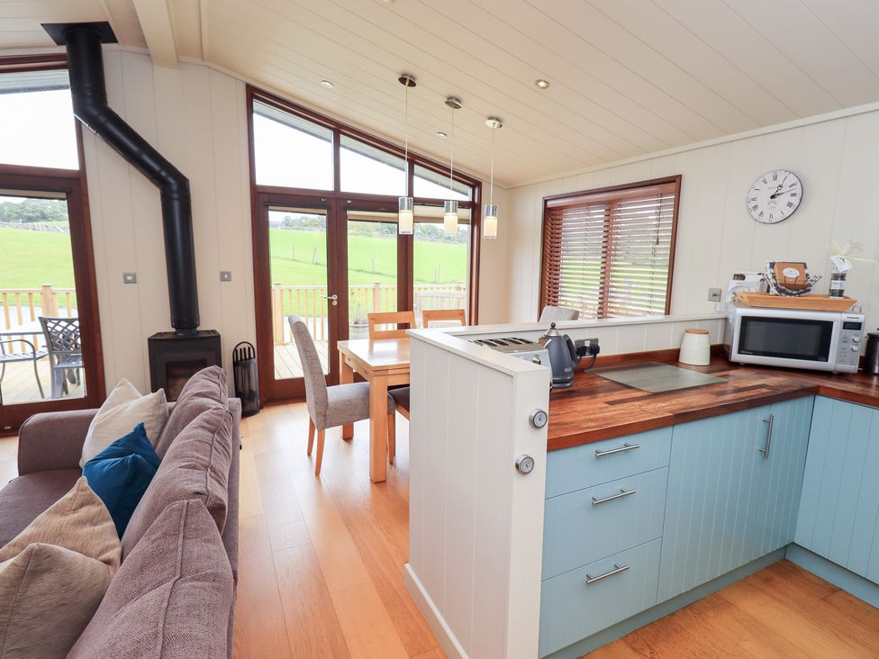 A kitchen with dining table and chairs at The Loghey in Hawkshead