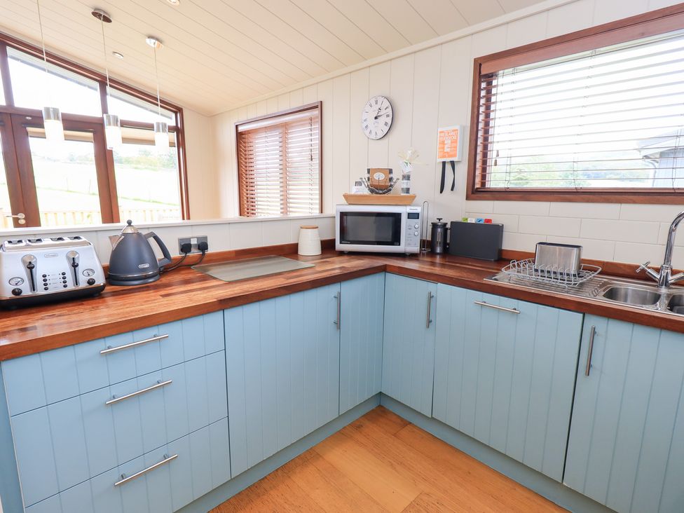 A kitchen with appliances and a sink at Thie Loghey in Hawkshead