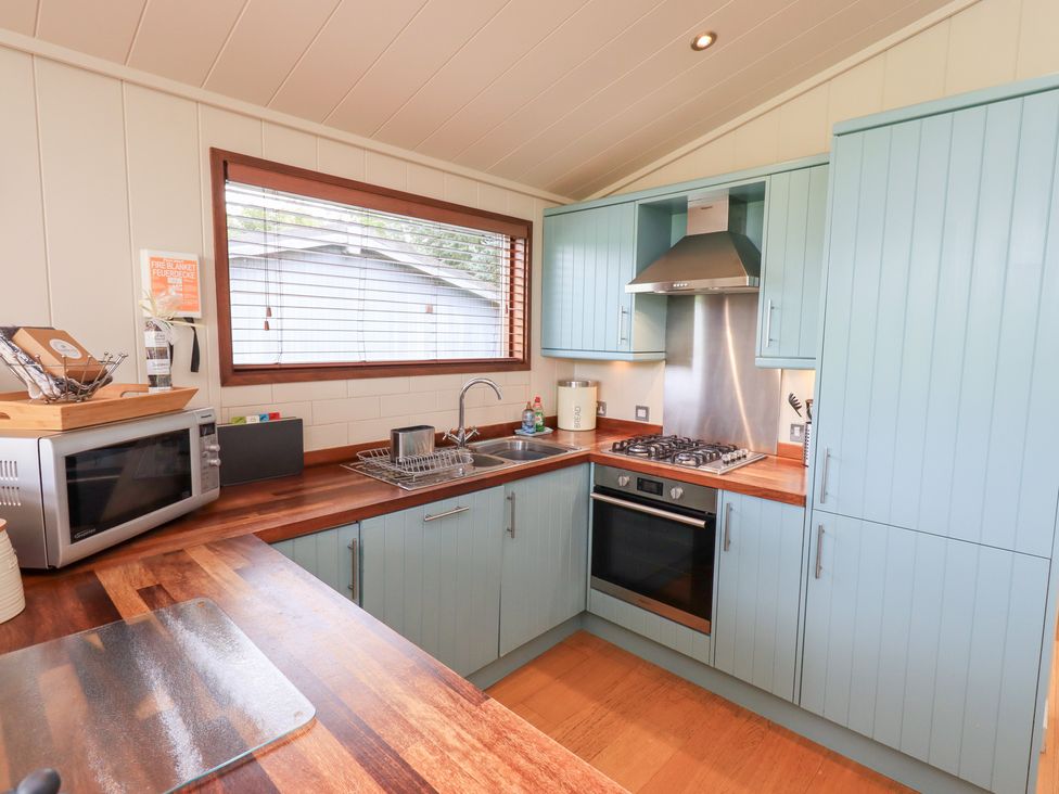 A kitchen with cabinets and appliances at The Loghey in Hawkshead