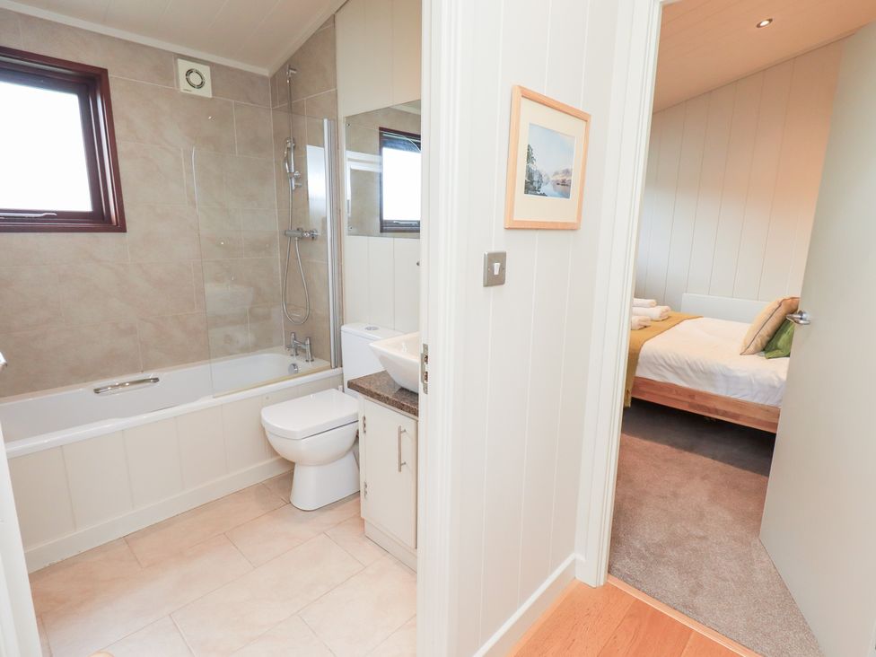 A bathroom with a bathtub and toilet at Thie Loghey in Hawkshead