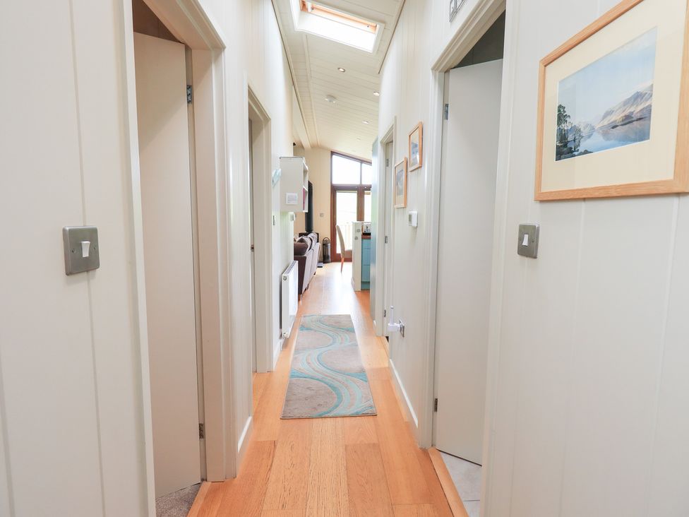 A hallway with doors and a rug at Thie Loghey in Hawkshead