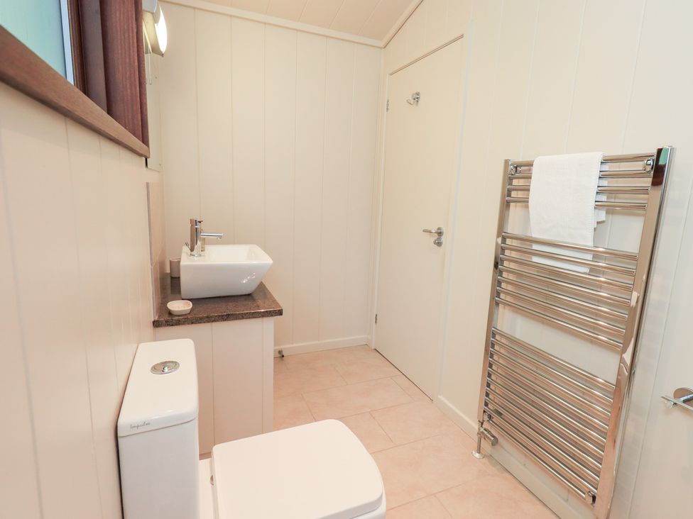 A bathroom with a toilet and sink at Thie Loghey in Hawkshead