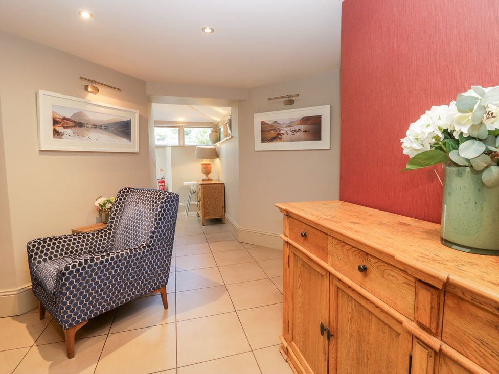 A hallway with a chair and sideboard at Archie's in Ambleside