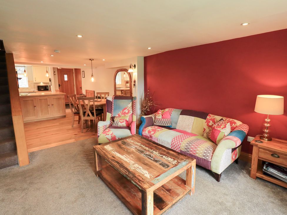 A living room with a sofa and coffee table at Boxwood Cottage in Troutbeck