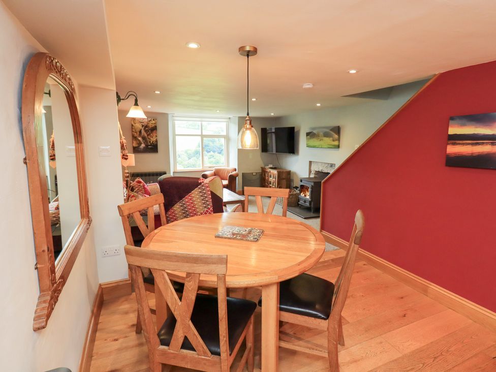 A dining room with a table and chairs at Boxwood Cottage in Troutbeck