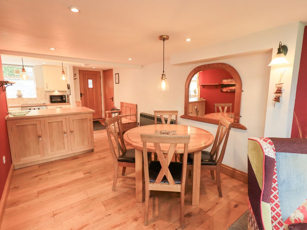 A dining area with a table and chairs at Boxwood Cottage in Troutbeck