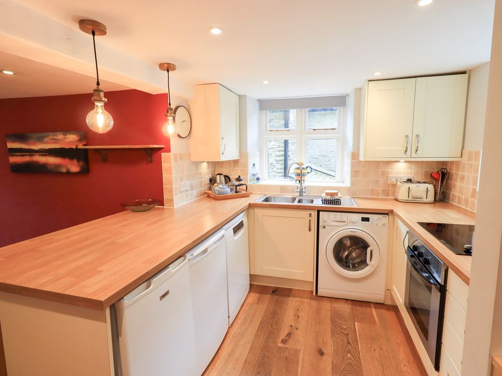 A kitchen with appliances and countertops at Boxwood Cottage in Troutbeck