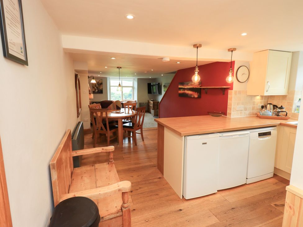 A kitchen with dining area and appliances at Boxwood Cottage Troutbeck