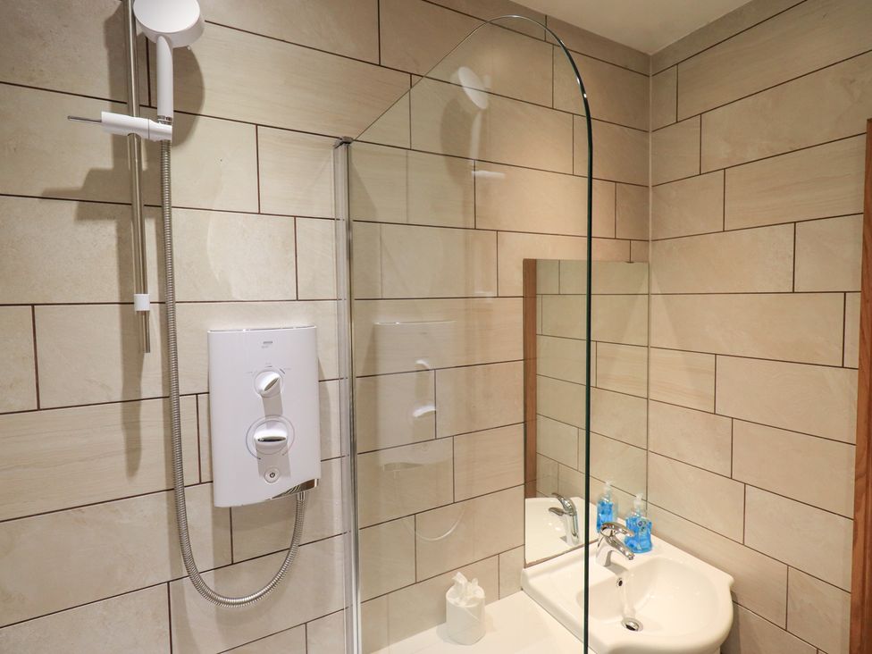 A bathroom with shower and sink at Boxwood Cottage in Troutbeck