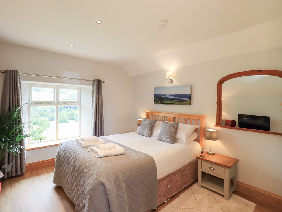 A bedroom with a bed and a television at Boxwood Cottage in Troutbeck
