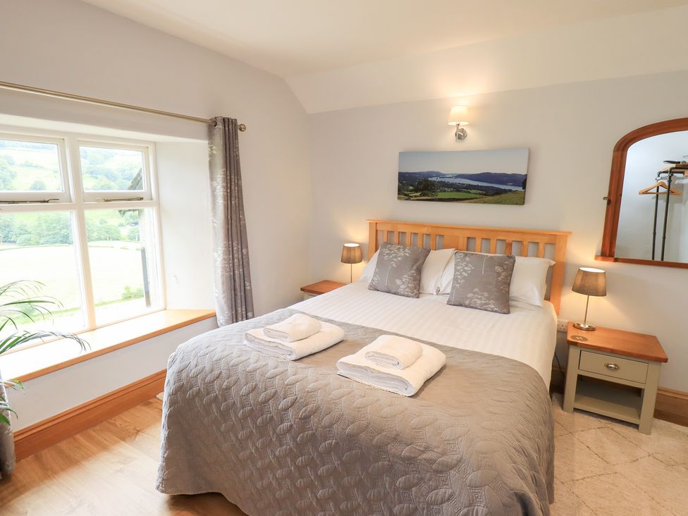 A bedroom with a bed and window at Boxwood Cottage in Troutbeck