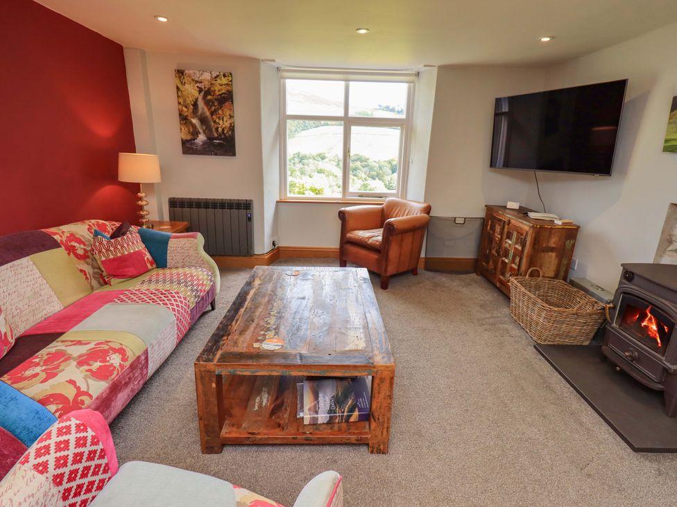 A living room with a sofa and coffee table at Boxwood Cottage in Troutbeck