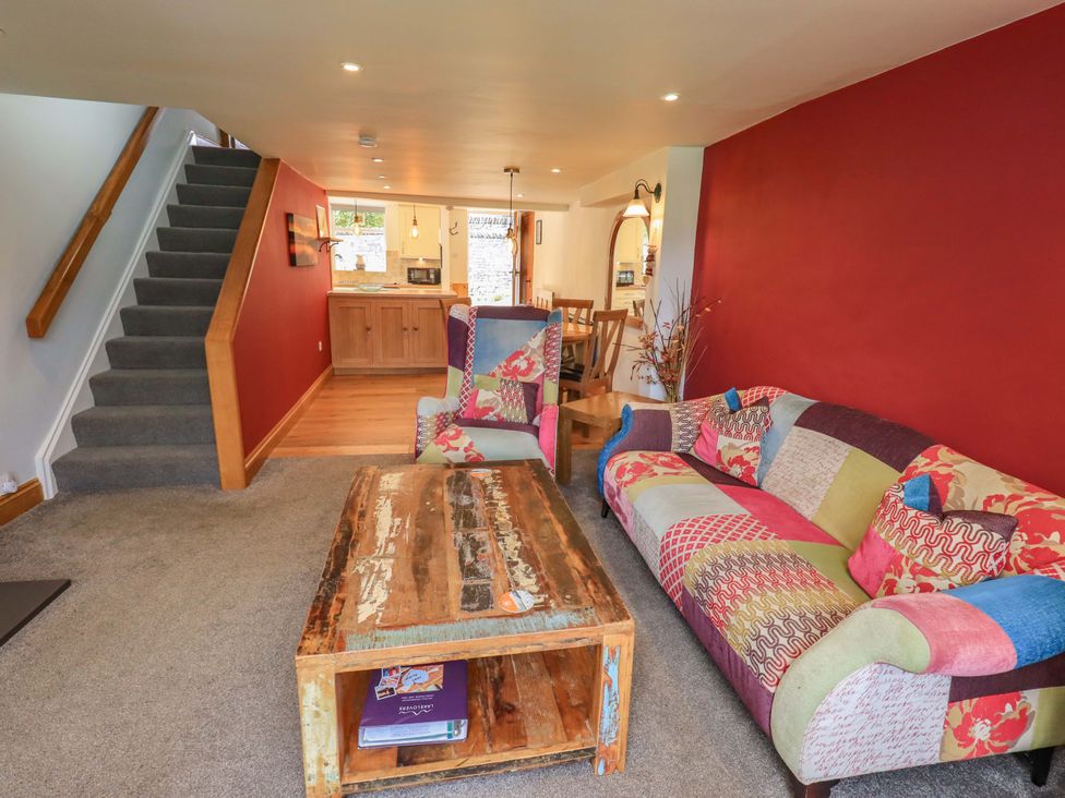 A living room with a sofa and coffee table at Boxwood Cottage in Troutbeck