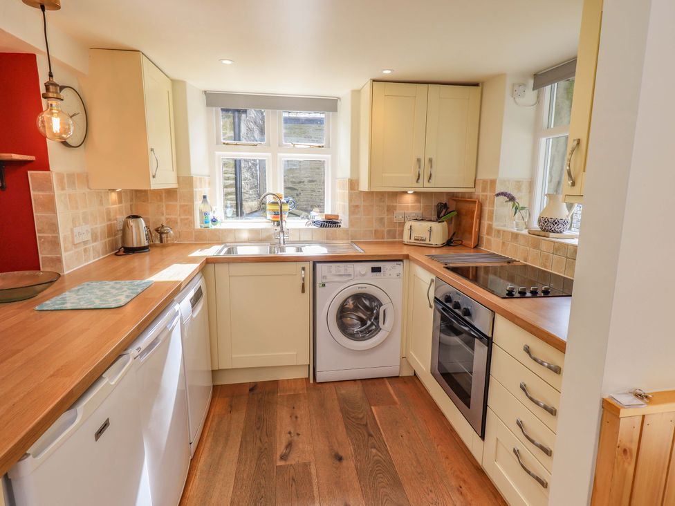 A kitchen with appliances and cabinetry at Boxwood Cottage in Troutbeck