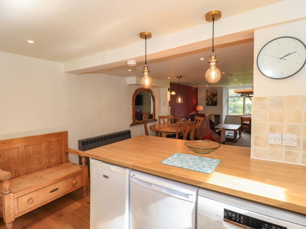 A kitchen with a table and chairs at Boxwood Cottage in Troutbeck