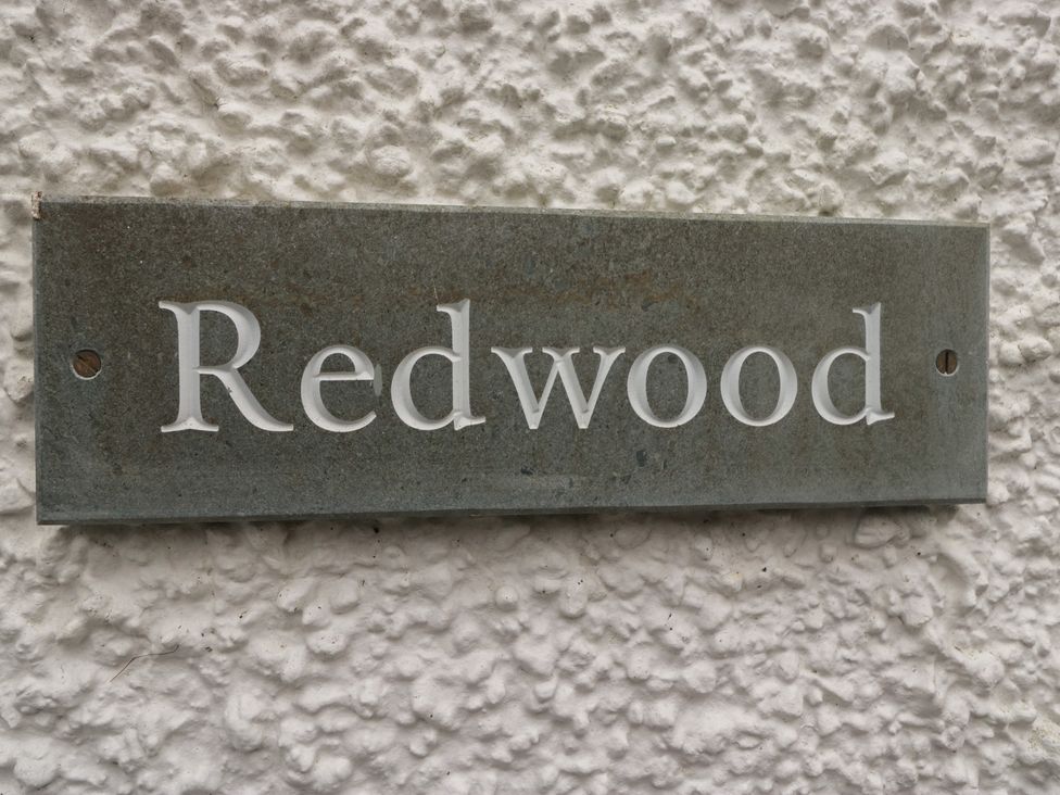 A nameplate with the text Redwood on a wall at Redwood in Ambleside