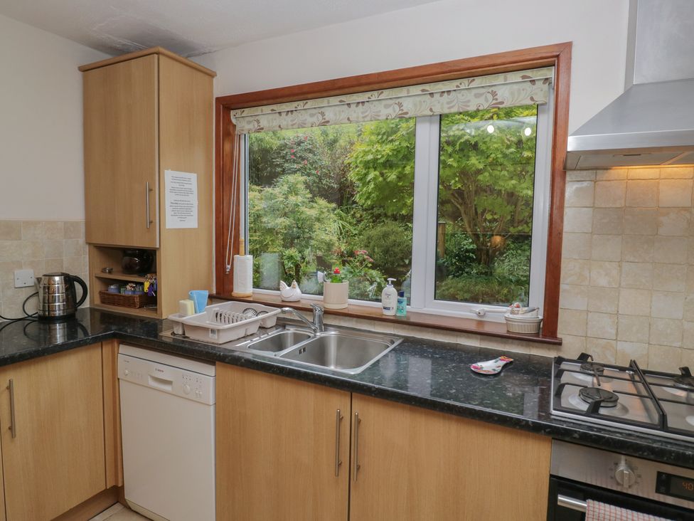 A kitchen with cabinets and sink at Redwood in Ambleside