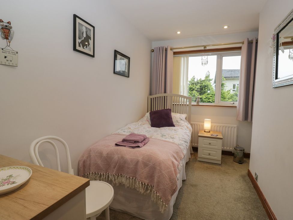 A bedroom with a single bed and nightstand at Redwood in Ambleside