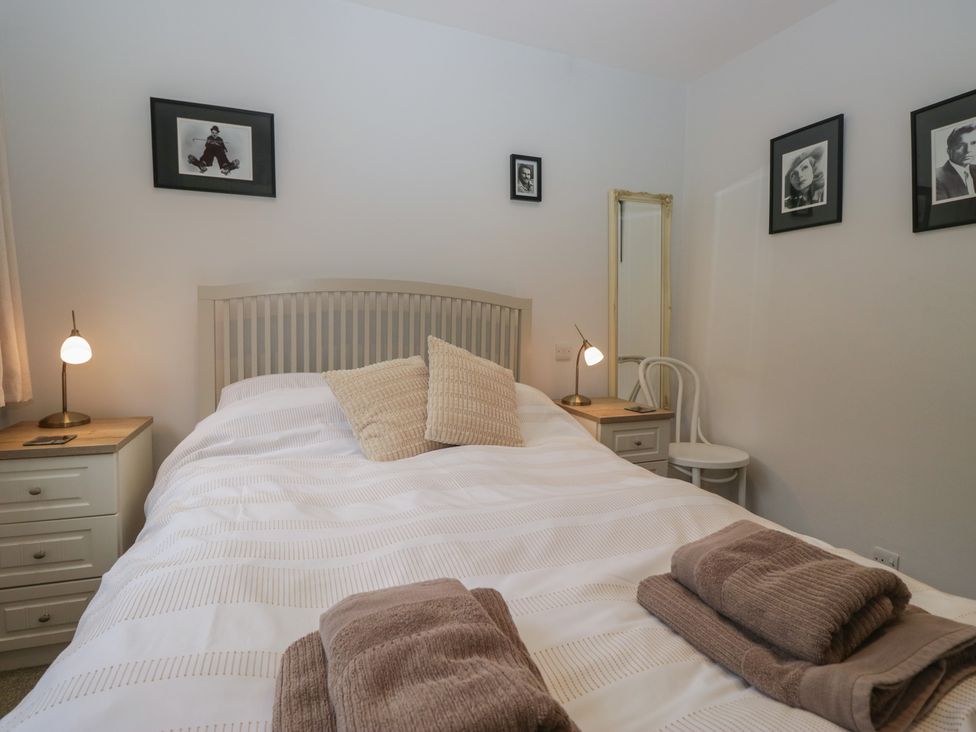 A bedroom with a bed and bedside table at Redwood in Ambleside