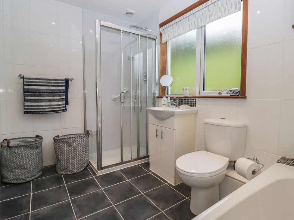 A bathroom with a shower, sink, and toilet at Redwood in Ambleside