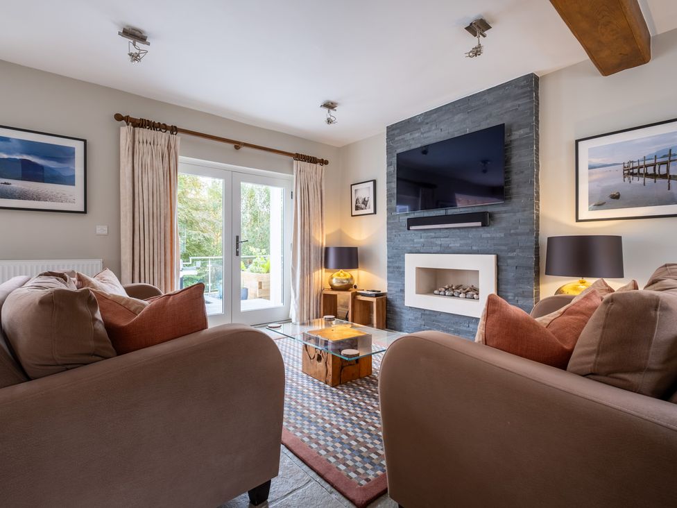 A living room with a television, sofa and coffee table at Goody Raise in Grasmere