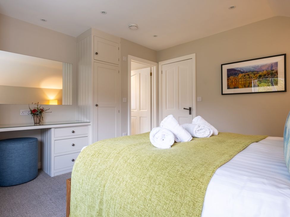 A bedroom with a bed and desk at Goody Raise in Grasmere